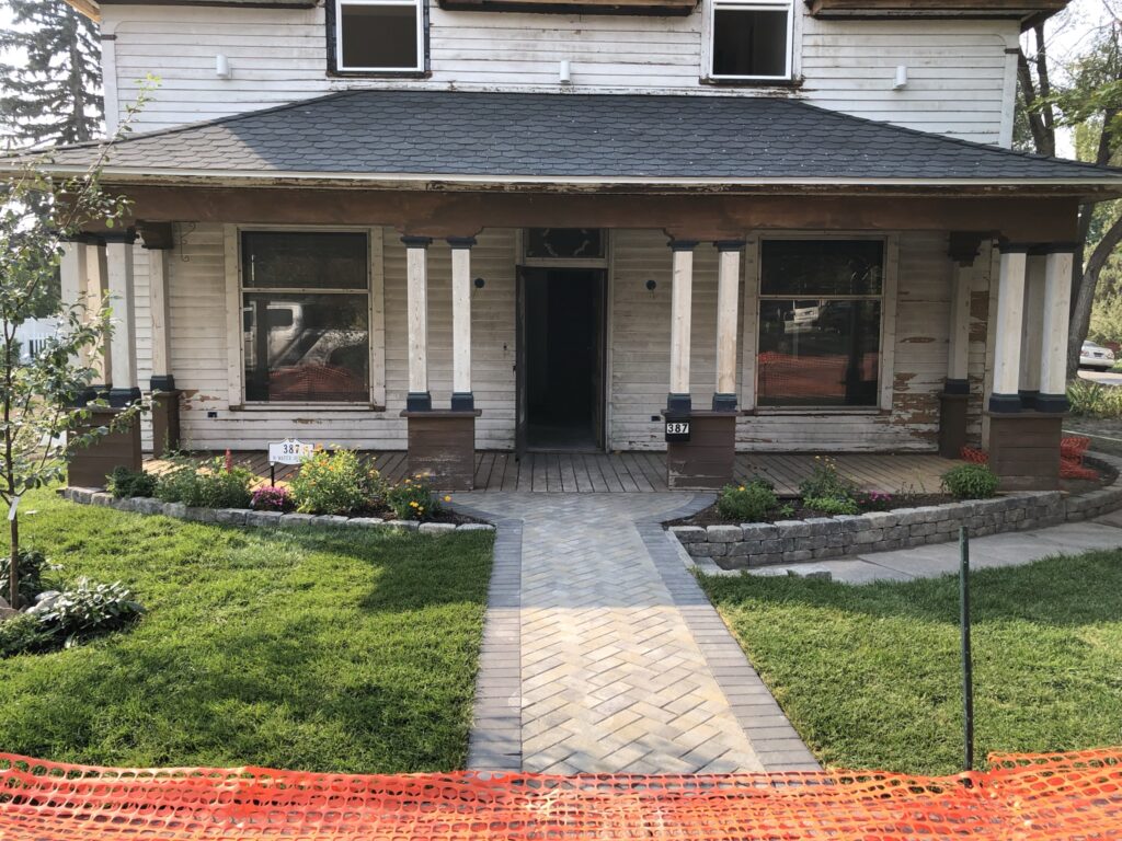 Install retaining wall and sod in the front garden