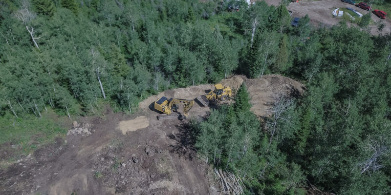 An aerial view of two diggers in field