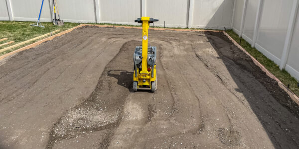 Compactor being used in residential property for foundation